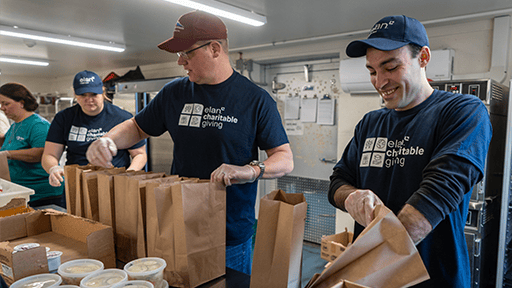 Elan volunteers packing food donations