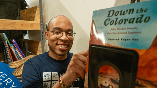 Smiling man packing items for a volunteer event