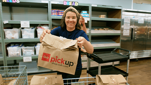 A woman holds a packed emergency box for the camera. 