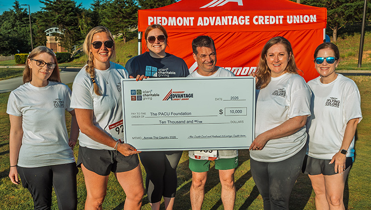 Representatives of Elan Credit Card stand and Piedmont Advantage Credit Union hold a large promotional check made out to the PACU Foundation as part of the Elan Charitable Giving program.