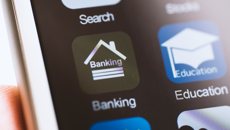 A close-up of a smart phone and its apps. The generic banking app is centered. 